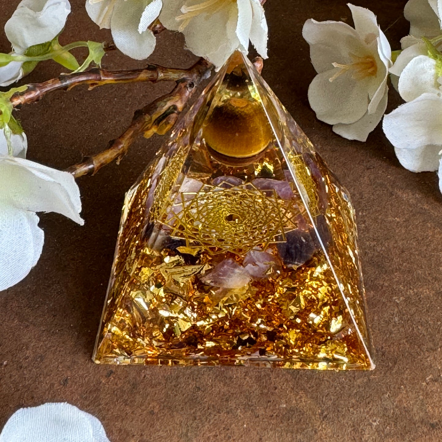 Orgonite pyramid with amethyst tiger eye and grid of life for energy balance, grounding, clarity, and emotional healing