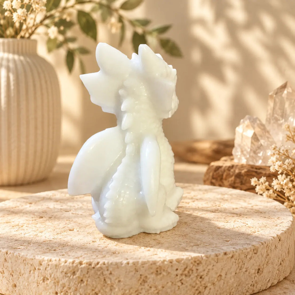 Hand-carved White Jade crystal dragon showing natural stone variation