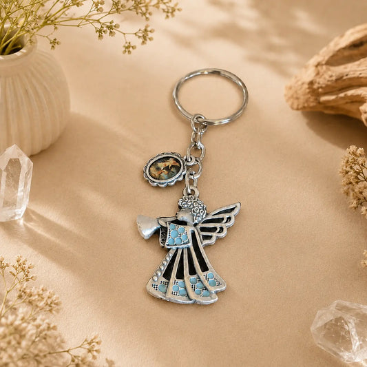 Silver Guardian Angel keyring with turquoise accents on a warm neutral background