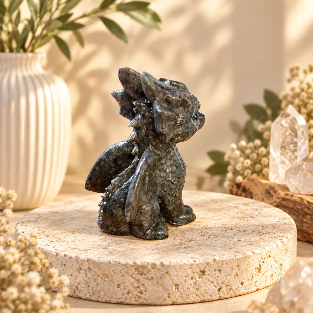 Hand-carved Astrophyllite crystal dragon showing natural mineral pattern