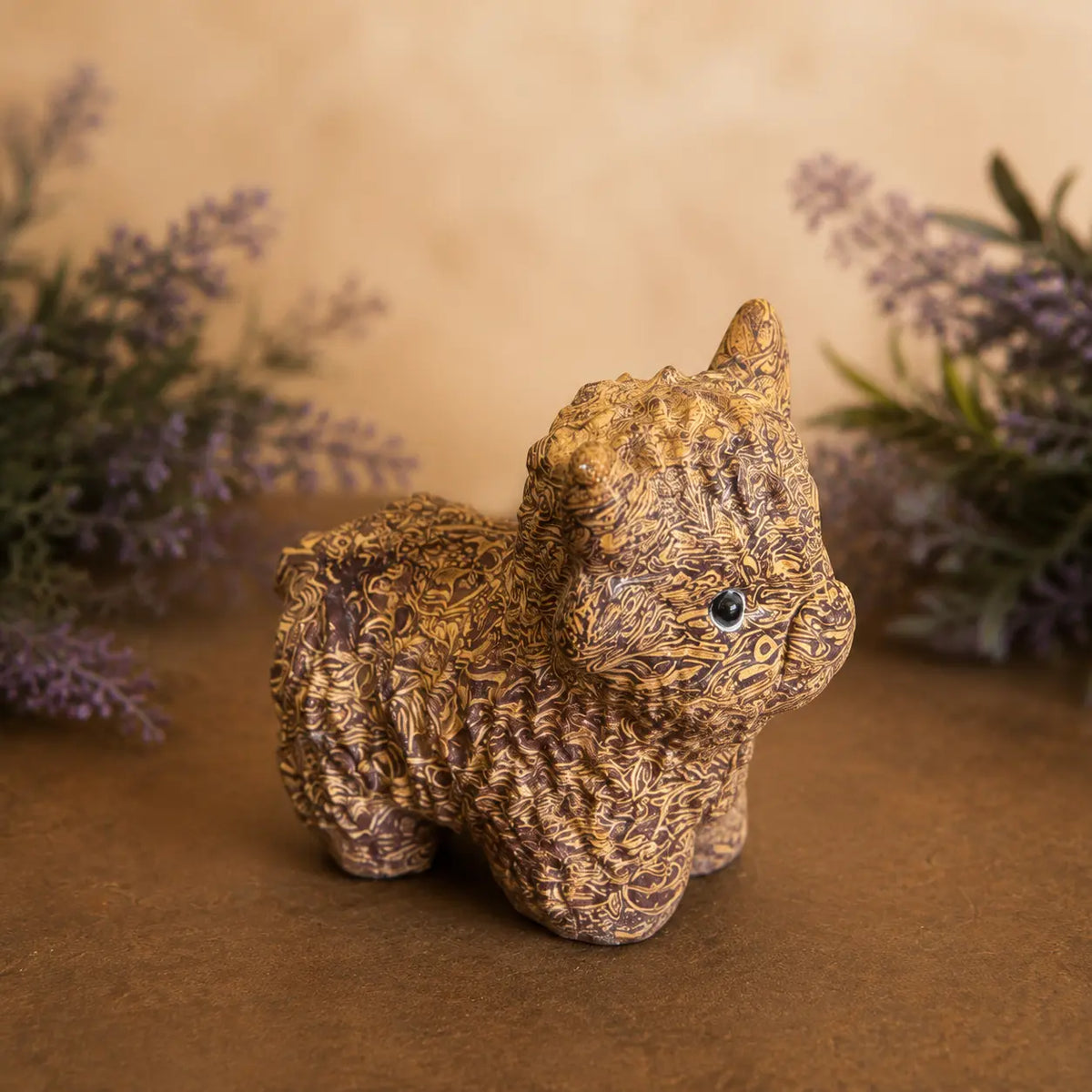 Calligraphy Jasper Highland Cow crystal carving with warm brown and cream script-like patterns and hand-carved details