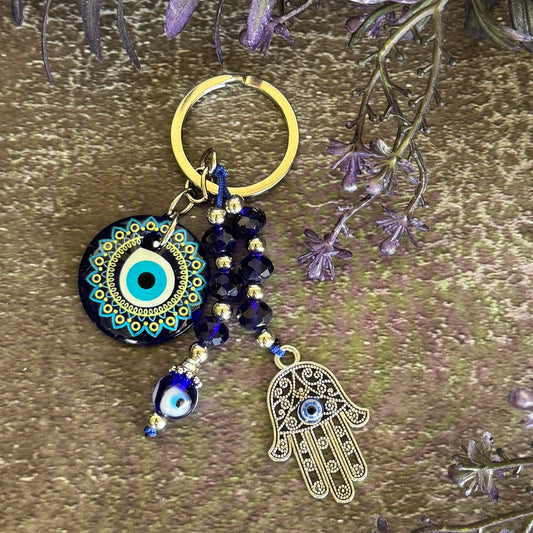 Evil Eye and Hamsa Hand keychain with large mandala glass Evil Eye disc, dark navy crystal beads and gold-tone Hamsa charm