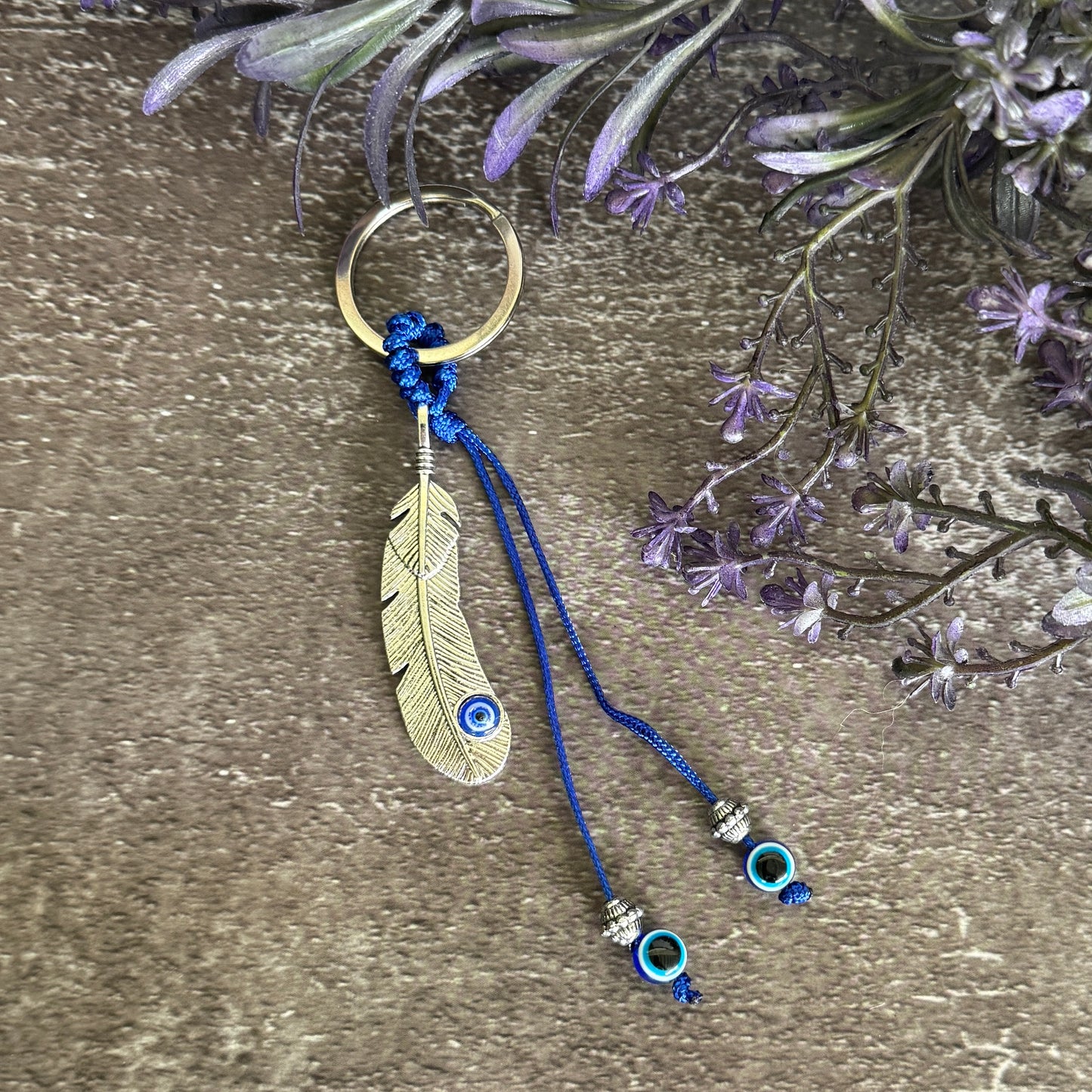 Silver-tone feather charm Evil Eye keychain with blue cord, silver-tone beads and blue Evil Eye beads