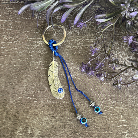 Silver-tone feather charm Evil Eye keychain with blue cord, silver-tone beads and blue Evil Eye beads