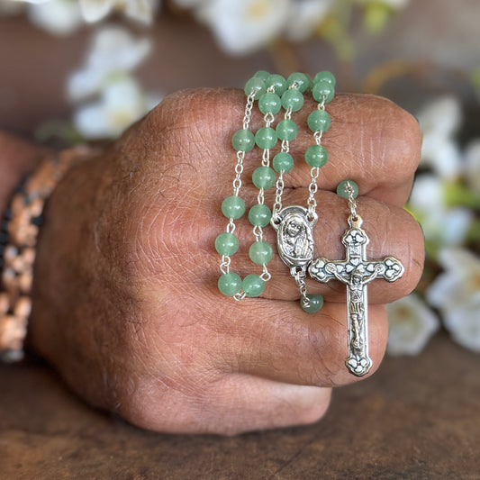 Green Aventurine Rosary crystal prayer beads with crucifix pendant displayed on a white surface