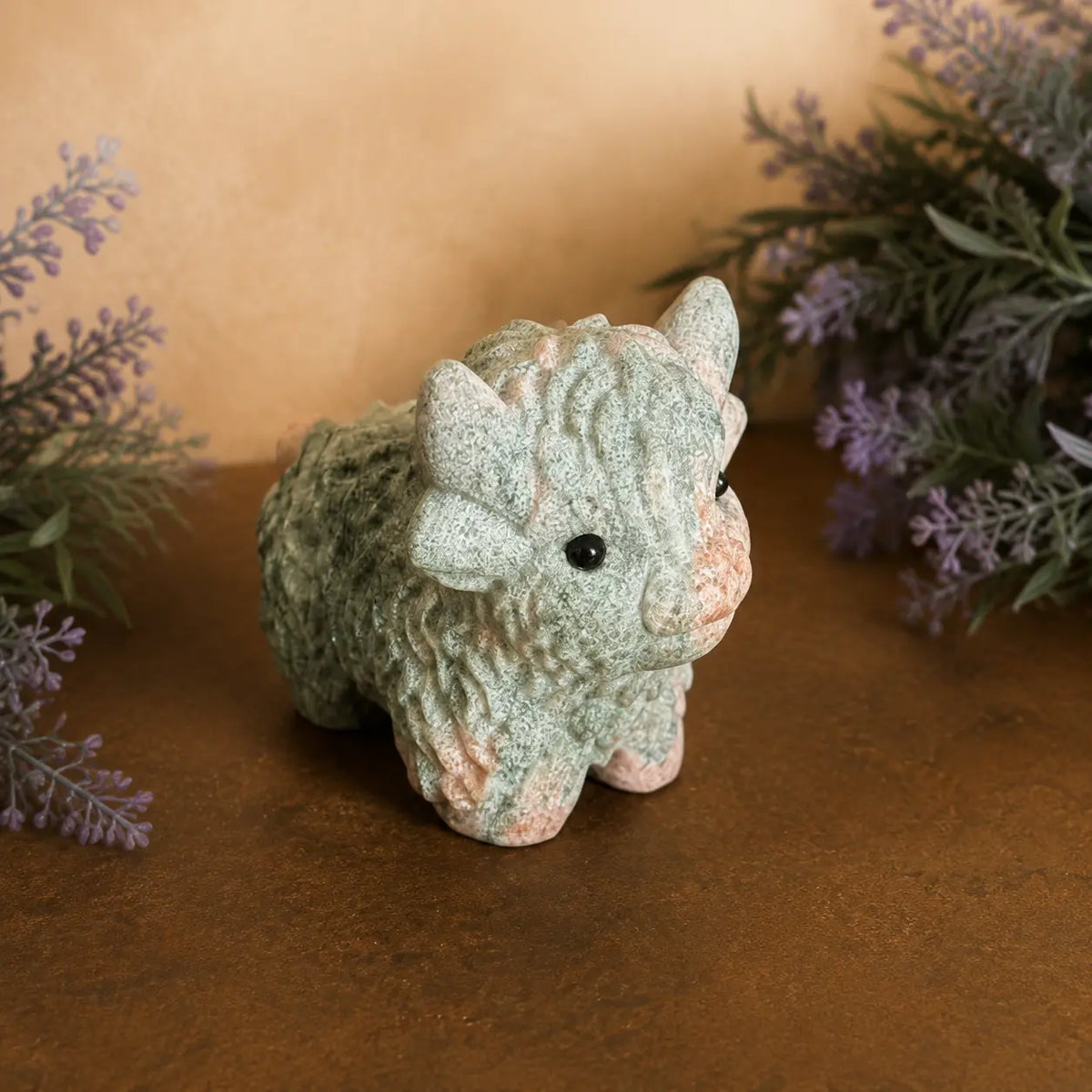 Pink Zebra Jasper Highland Cow crystal carving with  pink and grey banded patterns and hand-carved details