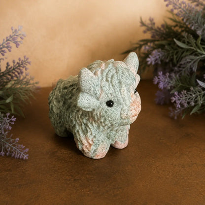 Pink Zebra Jasper Highland Cow crystal carving with  pink and grey banded patterns and hand-carved details