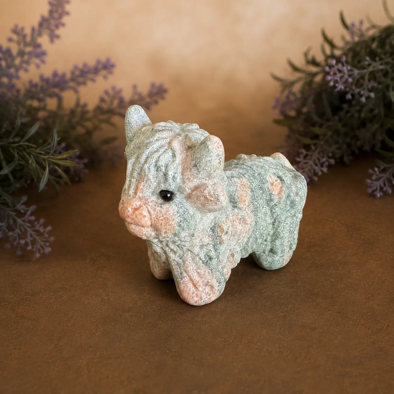 Pink Zebra Jasper Highland Cow crystal carving with  pink and grey banded patterns and hand-carved details