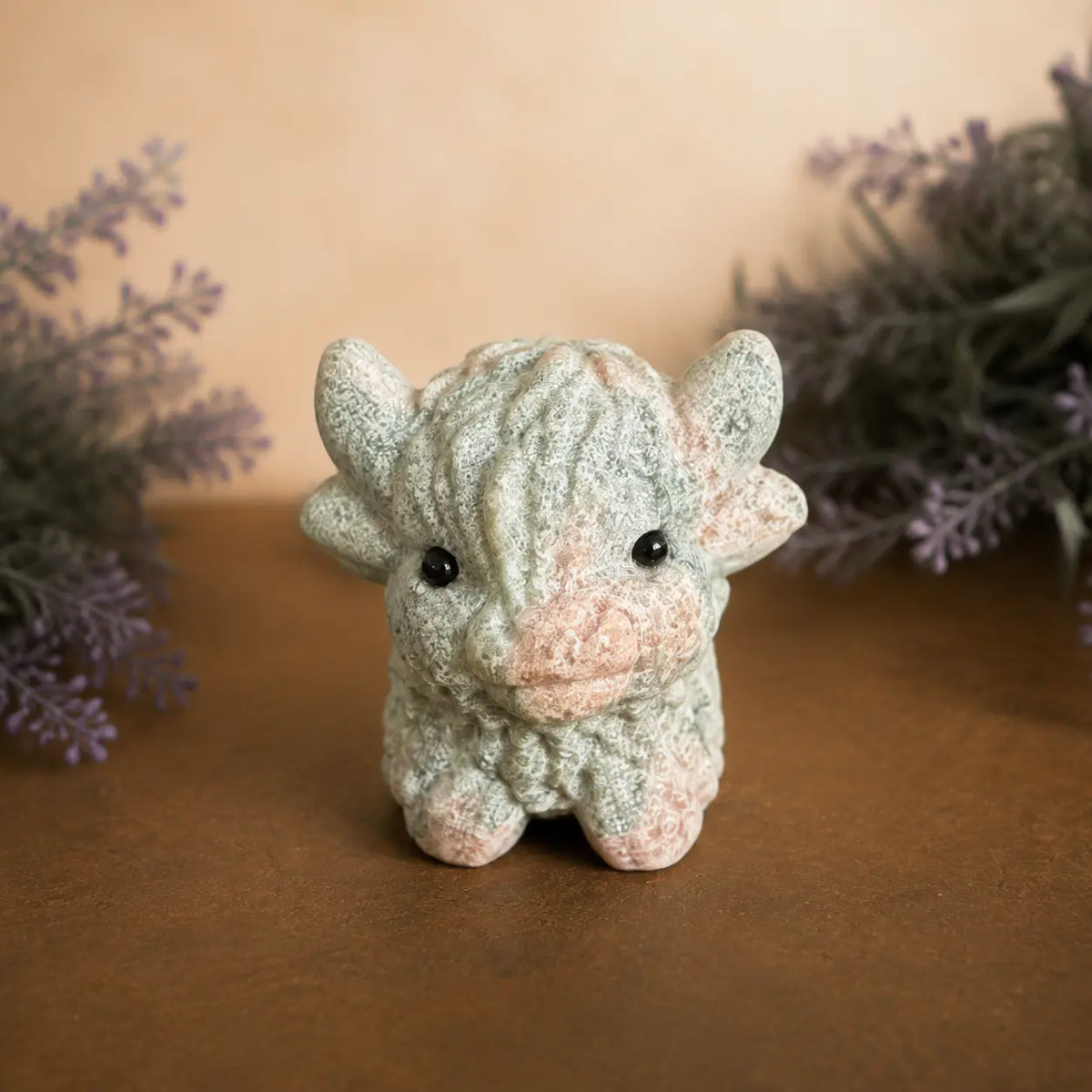 Pink Zebra Jasper Highland Cow crystal carving with  pink and grey banded patterns and hand-carved details
