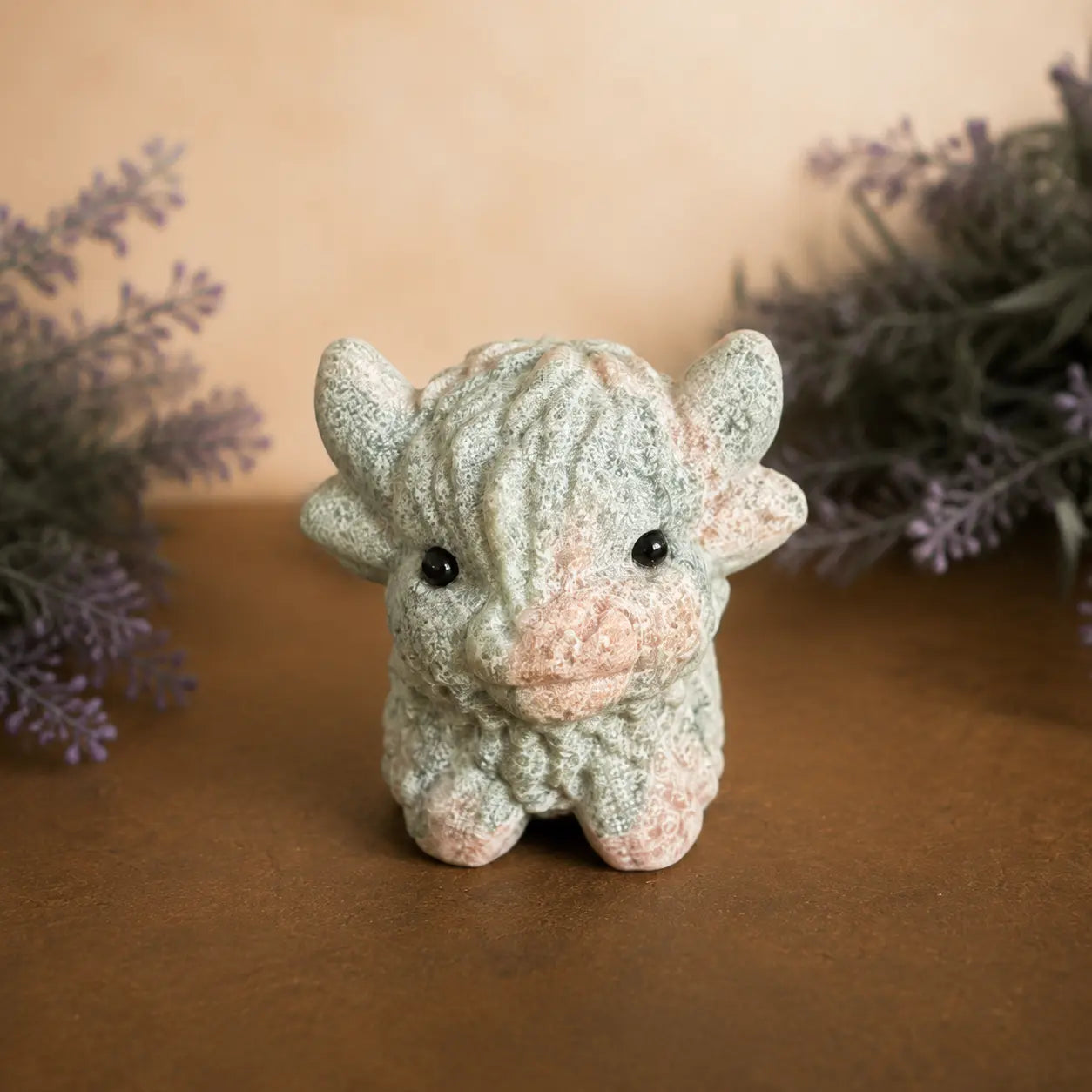 Pink Zebra Jasper Highland Cow crystal carving with  pink and grey banded patterns and hand-carved details