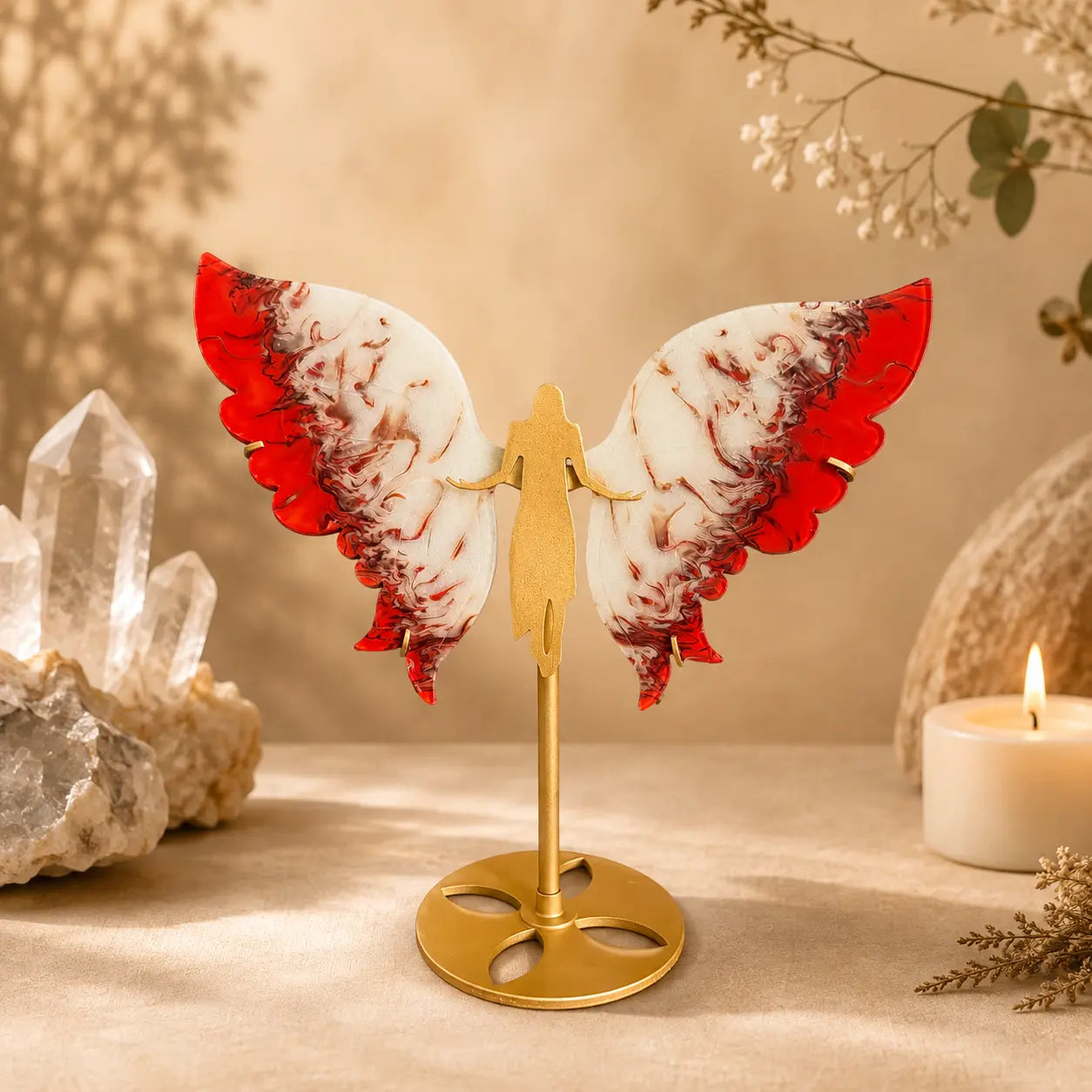 Red Flame Agate crystal wings on gold angel silhouette stand with vivid red and white swirling patterns.