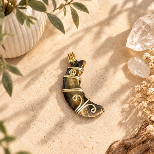 Tiger Eye moon pendant with loop, approximately 37mm, showing natural golden-brown chatoyancy.