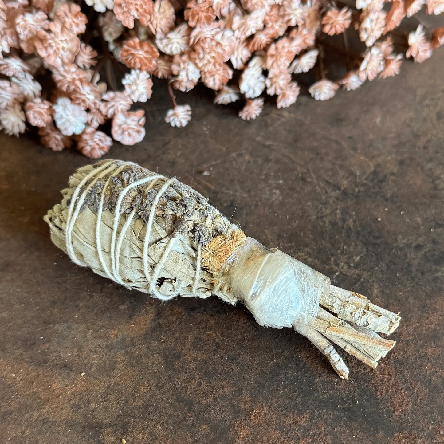 White Sage Torch Smudge Stick with Clear Quartz, Lavender, and wildflowers for energy cleansing, manifestation, calm, and spiritual protection.