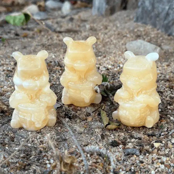 Orange Calcite Winnie the Pooh crystal carving for joy, confidence, emotional uplift, comfort, and pop culture collectible décor.