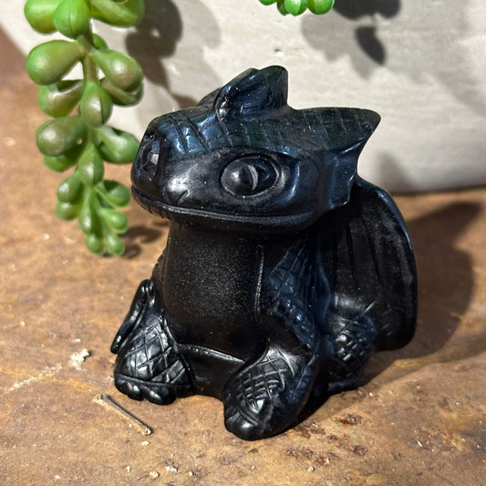 Polished Black Obsidian dragon crystal statue with detailed wings and expressive fantasy-inspired features